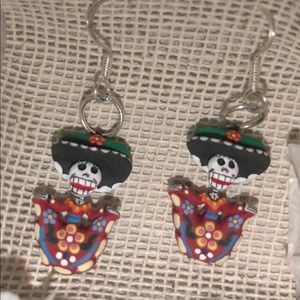 Handmade earrings made out of clay and silver.